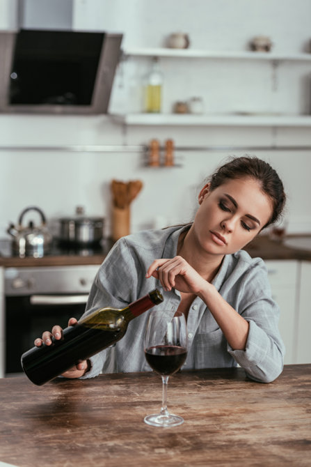 Woman is drinking wine at home