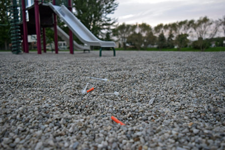 Children’s playground with used syringe needles.