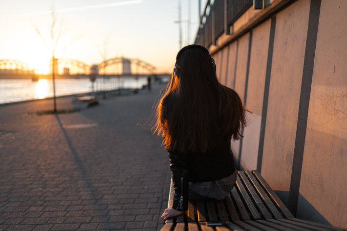 Young woman in recovery is enjoying sunrise.