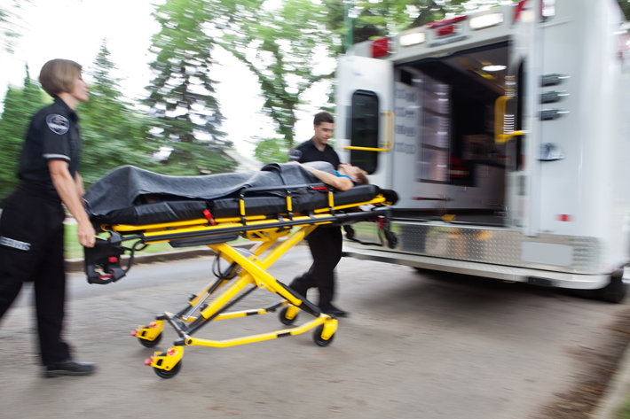 Person on stretcher being taken into an ambulance